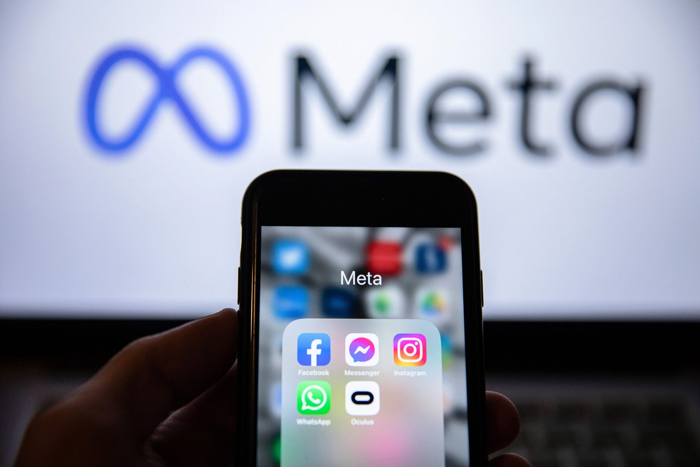 Meta logo with facebook and Instagram apps in foreground