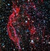 NASA's Hubble Space Telescope images the glowing red tendrils of gas from the supernova remnant, DEM L249.