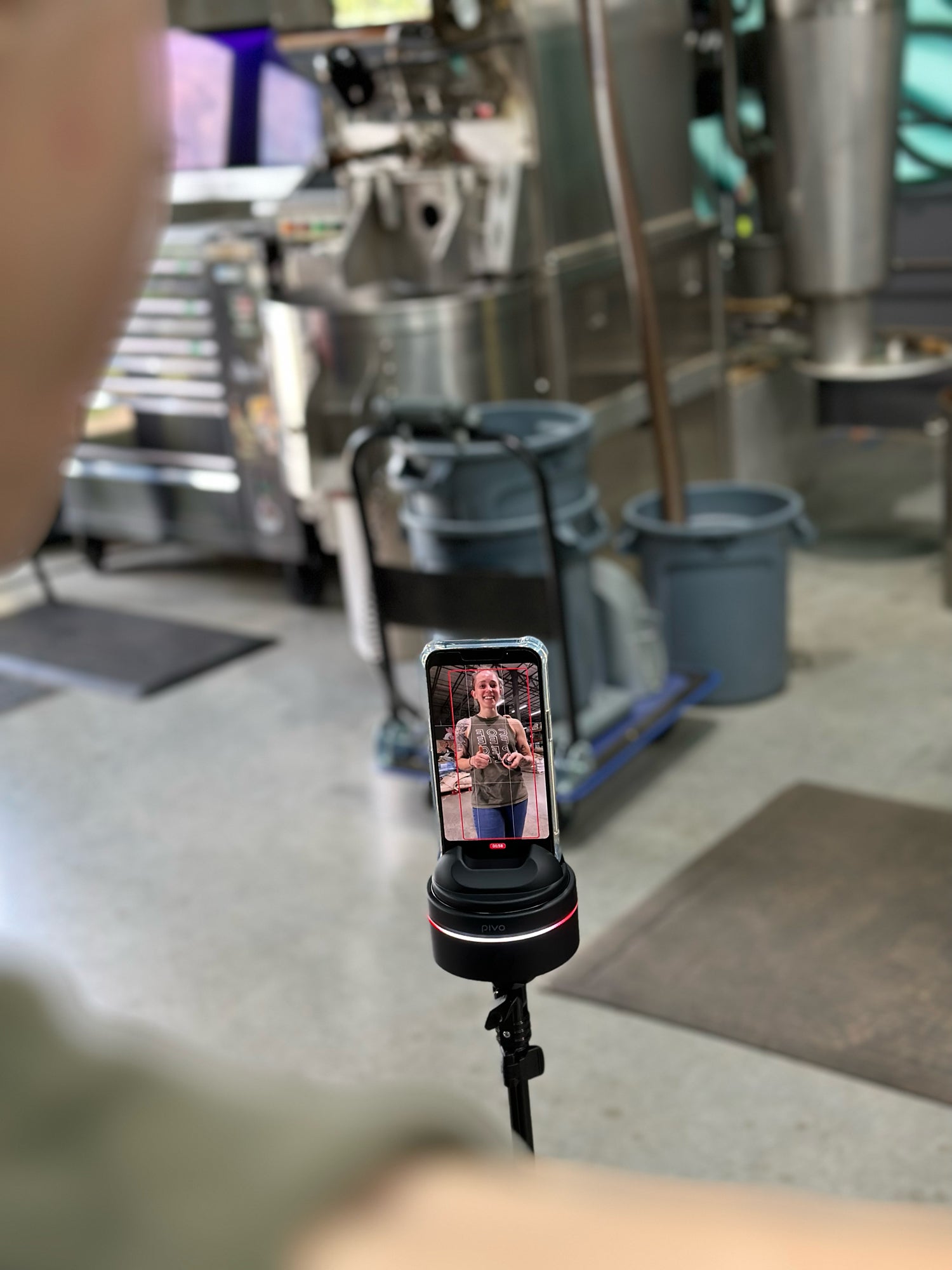 A person records themselves in a warehouse using the Pivo Max 